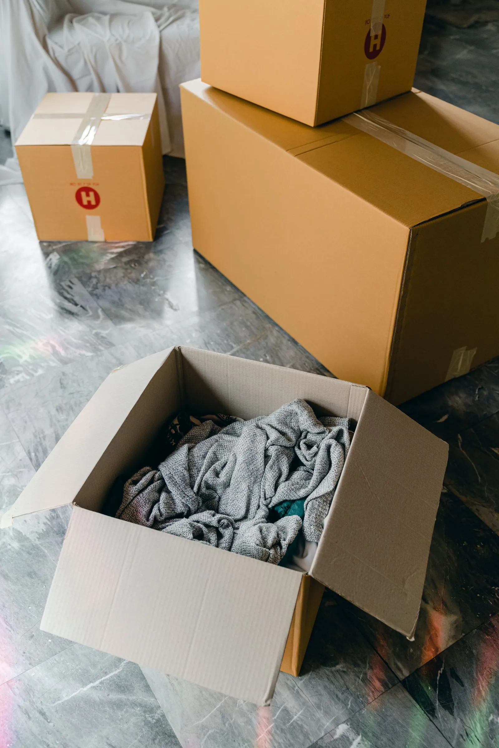 packed boxes and covered furniture during a property clearance